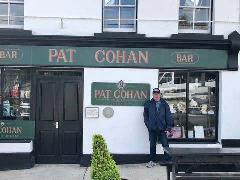 Man standing in front of Pat Cohan bar.