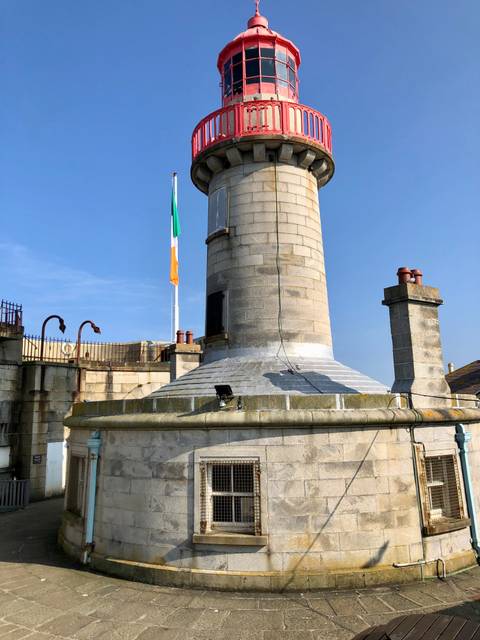       Lighthouse with Irish flag.
  