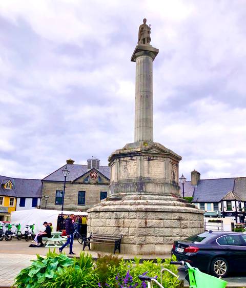       Stone monument in a square.
  