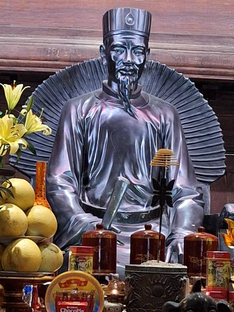 Close-up of a statue with flowers.