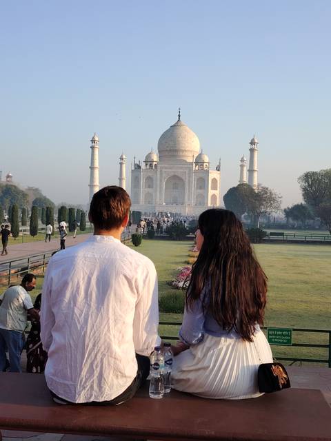 Couple admiring the Taj Mahal gardens.