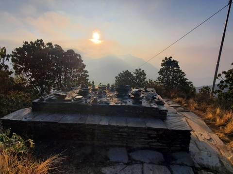 Mountains with the sun setting behind them.