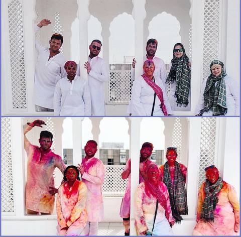 Group of people celebrating with bright colors and white attire.
