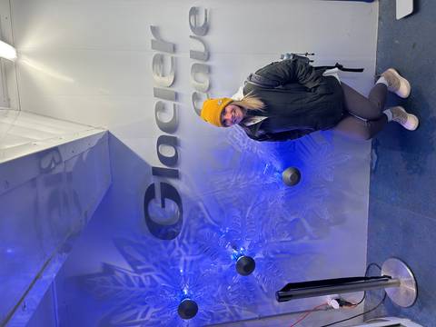 Person posing against a wall with 'Glacier' text.