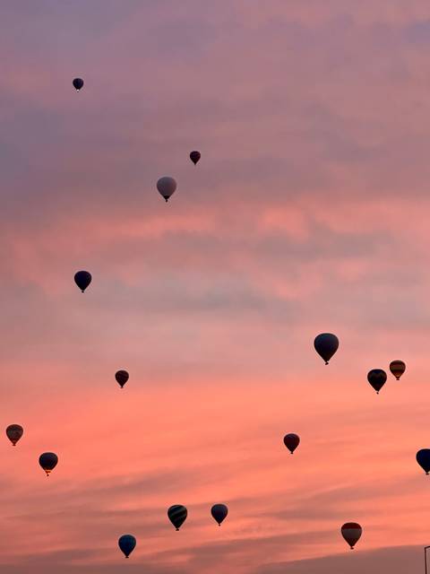 Hot air balloons in the sky at sunrise.
