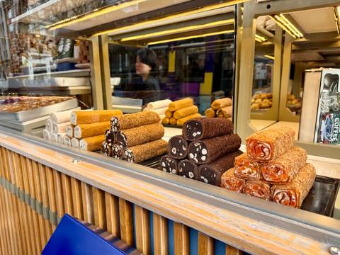 Colorful sweets on display in a shop window.