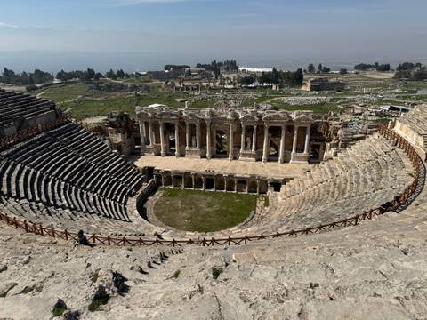 Ancient amphitheater with surrounding landscape.