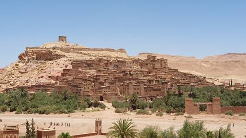       Historic fortified village with earthy tones in a desert landscape.
  