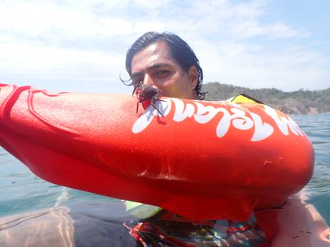 Person holding a floating device with a crab on it.