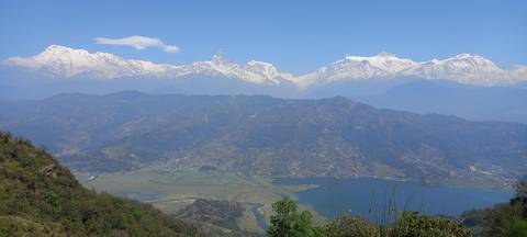 Panoramic view of mountains with a lake in the foreground.