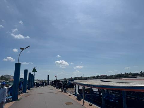       Dockside view with a busy harbor and clear skies.
  