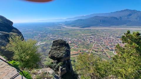 A scenic view from a high vantage point overlooking a town and valley.