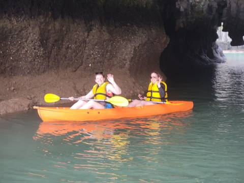       Two people kayaking inside a cave.
  