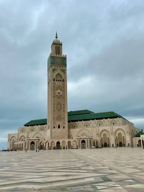       Hassan II Mosque with its tall minaret and traditional architecture.
  
