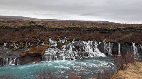       Flowing waterfalls with clear, blue water.
  