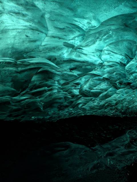       Intricate ice formations with a blue-green tone.
  