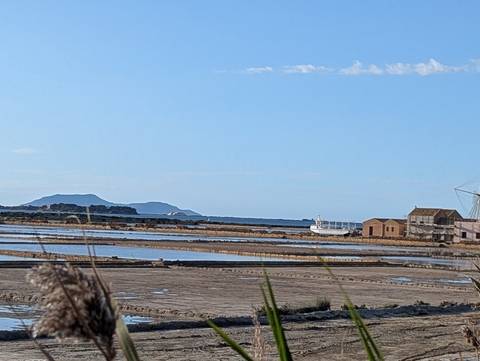       Coastal landscape with water and distant islands.
  