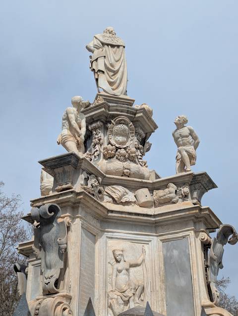 Ornate fountain with statues adorned with intricate carvings.