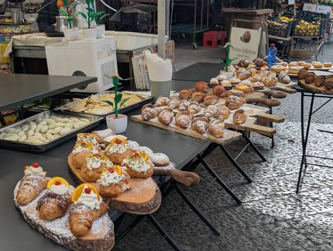       Selection of traditional pastries and sweets on a market stand.
  