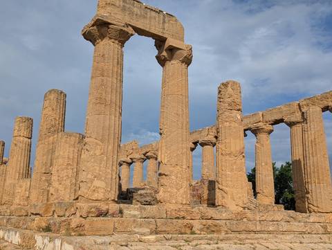 Ancient stone columns with a clear sky backdrop.