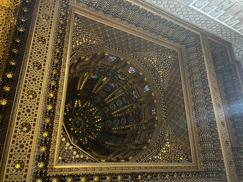 Intricately decorated ceiling with patterns and stained glass.