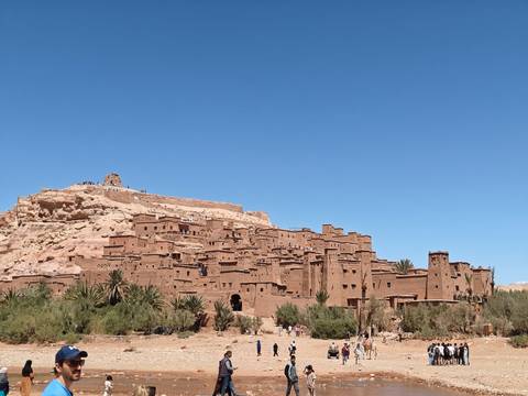 Ait Benhaddou with clear skies and surrounding nature.