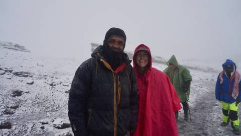 People in winter gear standing in a snowy landscape.