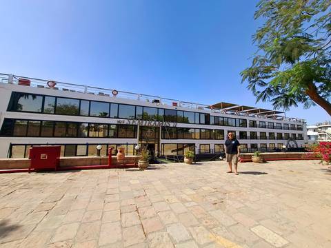       Person standing in front of a cruise ship
  
