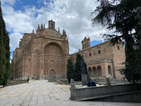 Historic cathedral with ornate architecture and green scenery.