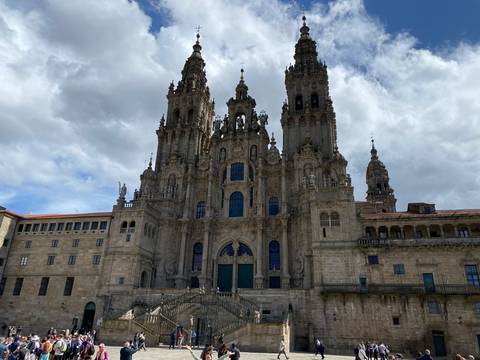 Ornate cathedral with baroque architecture under a partly cloudy sky.