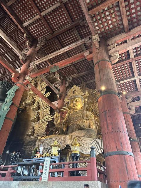 Interior of a temple with a large golden statue.