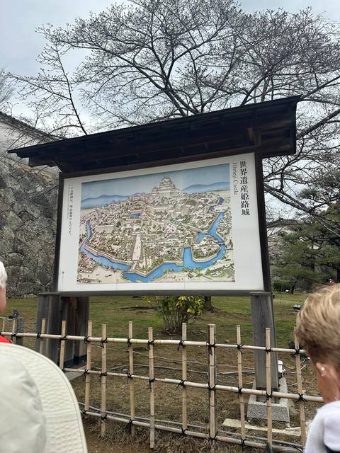 Illustrated map of Himeji Castle displayed on a board.