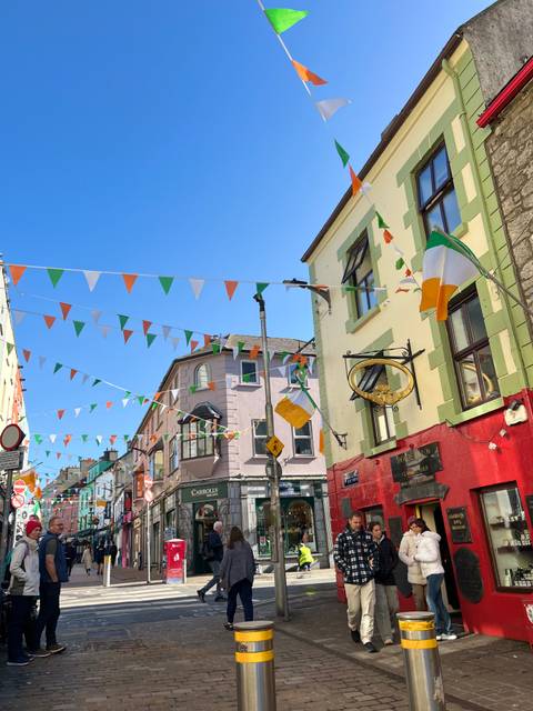 Street decorated with Irish flags and bunting.