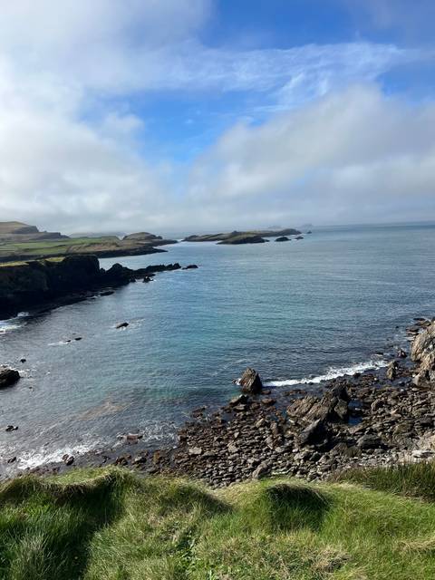 Expansive view of rocky coastline and open sea.