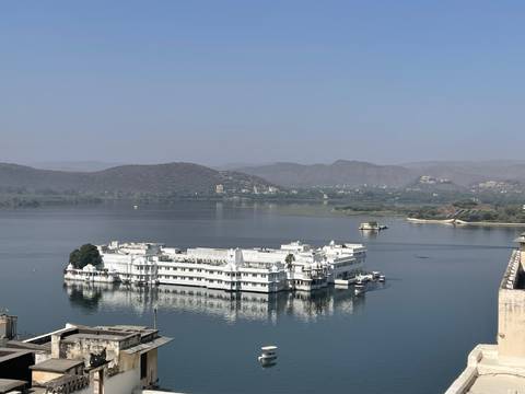       Palatial white building floating on a lake.
  