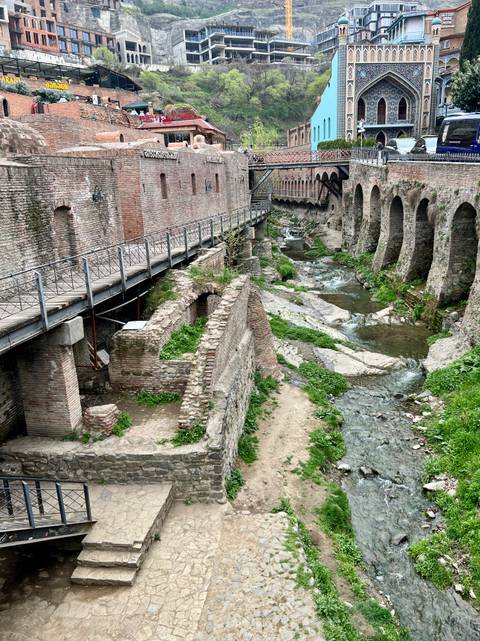       Historic brick structures over a flowing creek.
  
