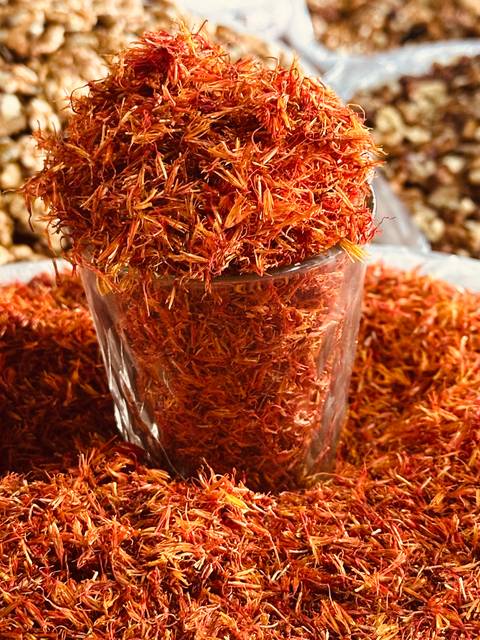       Glass of dried safflower petals.
  