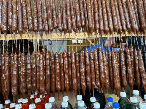       Rows of stacked churchkhela hanging.
  