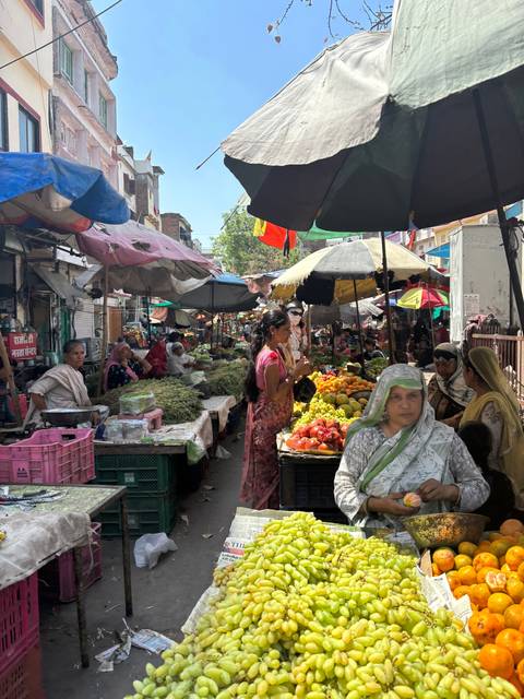       Vibrant Indian market with multiple stalls.
  