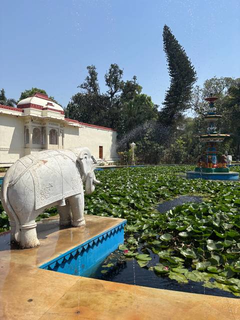       Water garden with sculptures and lotuses.
  