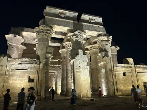An ancient Egyptian temple illuminated at night.