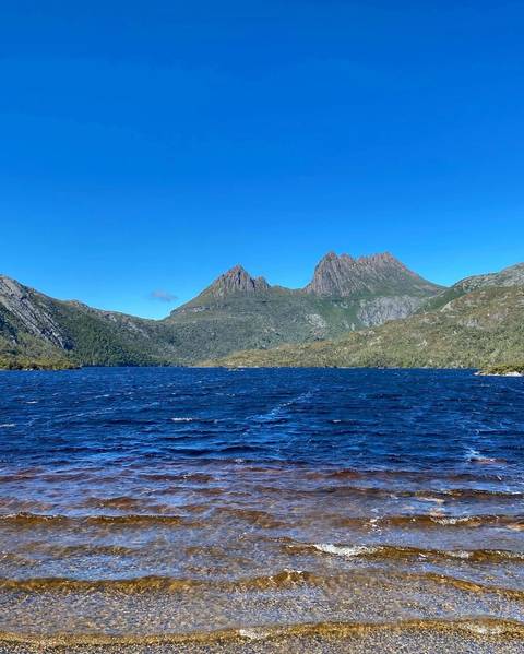 Mountainous landscape with a lake under blue sky