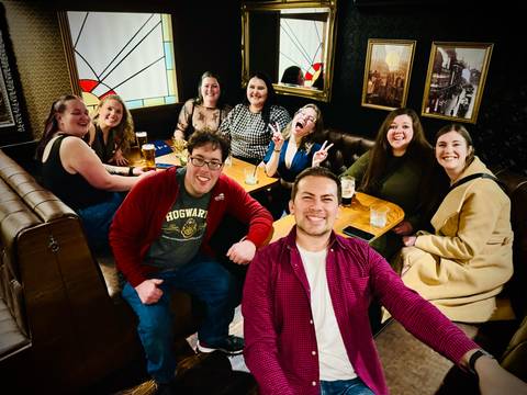 Group of friends in a pub enjoying drinks.