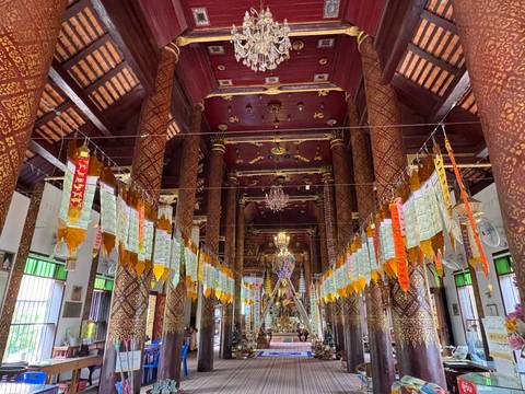 Intricate temple interior with hanging flags.