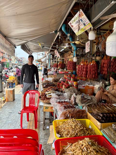 Bustling market scene with seafood and sausages.