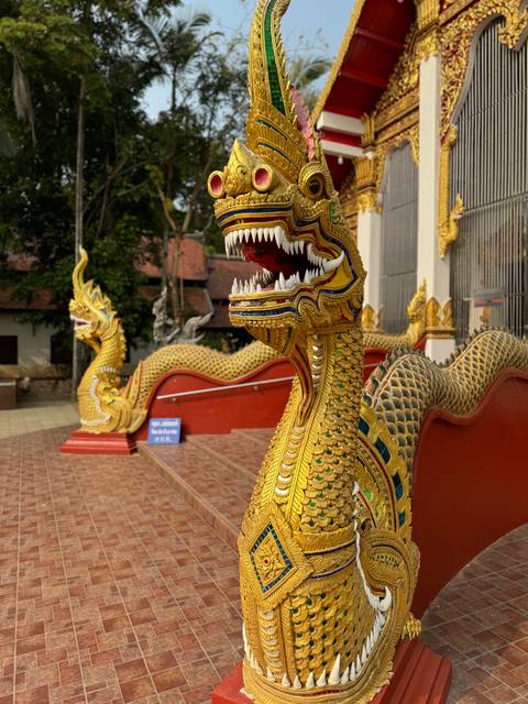 Golden serpent statues with intricate design.