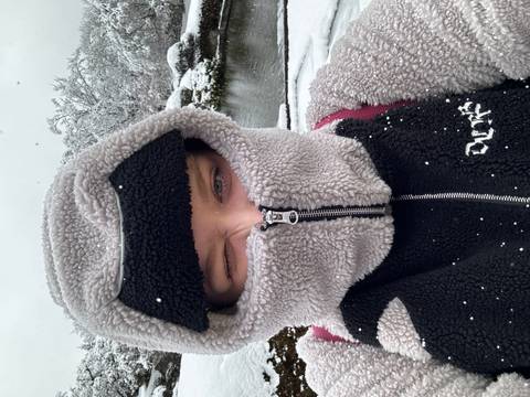 A person bundled warmly in a snowy setting.