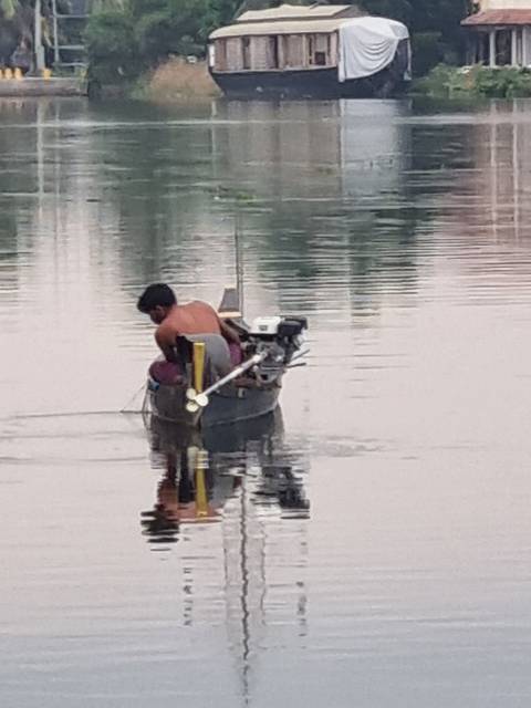       Person fishing on a small boat.
  