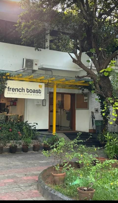      Bakery storefront with a sign for 'French Toast'.
  