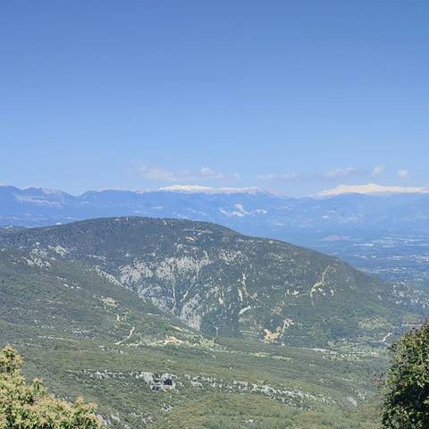       View of distant mountains with snow caps.
  